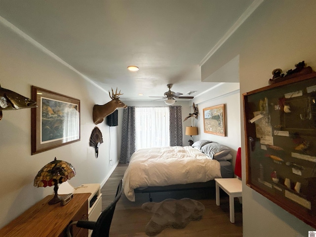 bedroom with ceiling fan and wood-type flooring