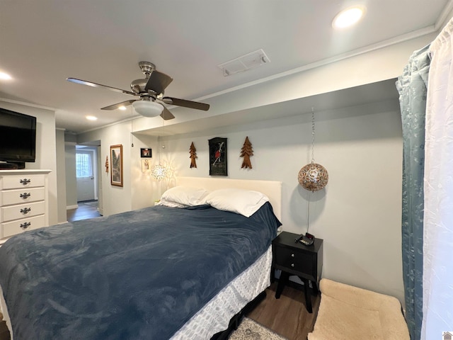 bedroom featuring ceiling fan, crown molding, and wood-type flooring