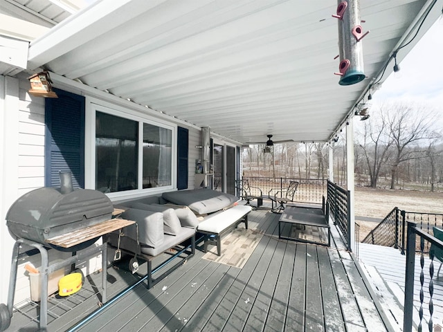 wooden terrace with a grill, ceiling fan, and covered porch