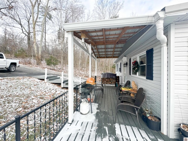 snow covered deck featuring area for grilling