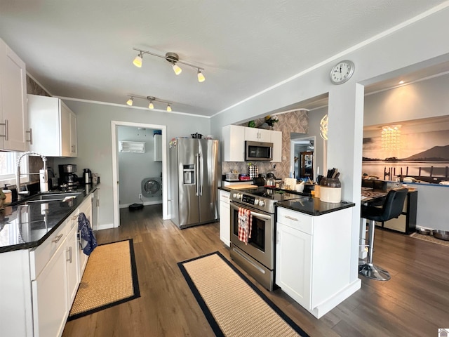 kitchen featuring sink, stainless steel appliances, dark hardwood / wood-style flooring, backsplash, and white cabinets