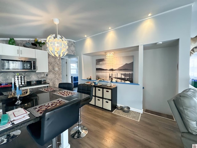 kitchen featuring a notable chandelier, white cabinets, tasteful backsplash, decorative light fixtures, and dark hardwood / wood-style flooring