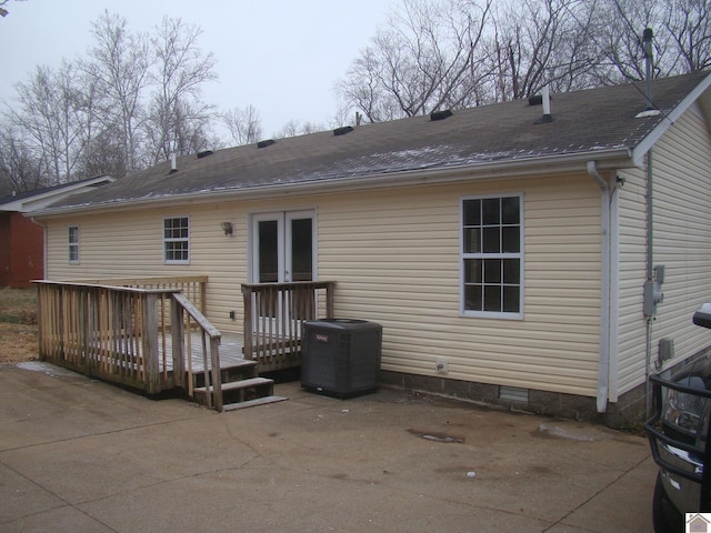 back of property with central air condition unit, a patio area, french doors, and a deck