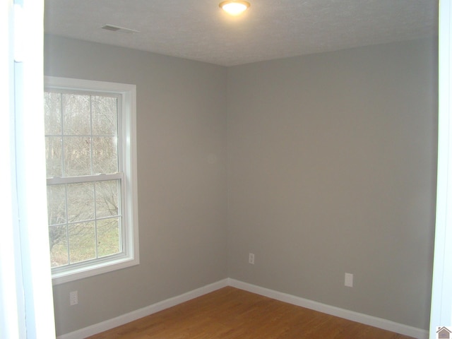 spare room featuring hardwood / wood-style flooring