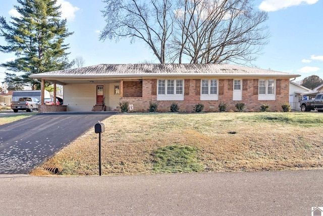 ranch-style home with a front yard and a carport