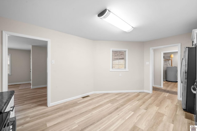 unfurnished room with light wood-type flooring