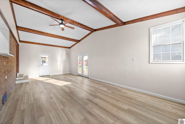 unfurnished living room with ceiling fan, lofted ceiling with beams, and light wood-type flooring