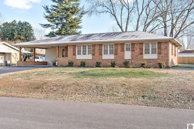 ranch-style home with a front lawn and a carport