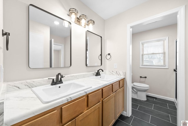 bathroom with tile patterned floors, vanity, and toilet