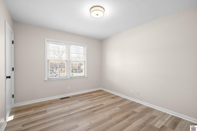 unfurnished room with light hardwood / wood-style floors