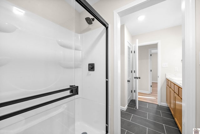 bathroom with tile patterned flooring, vanity, and an enclosed shower