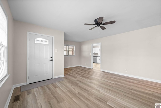 foyer entrance featuring light wood-type flooring and ceiling fan