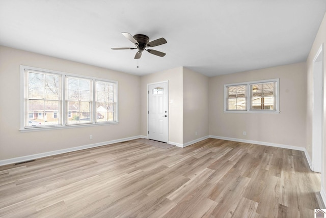 unfurnished room with ceiling fan, a healthy amount of sunlight, and light hardwood / wood-style floors