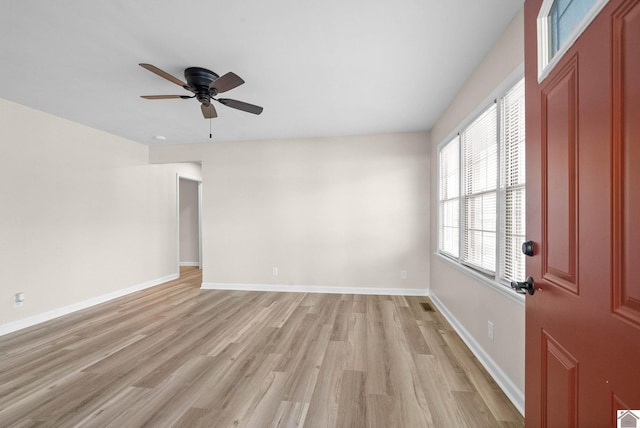 spare room with light wood-type flooring and ceiling fan