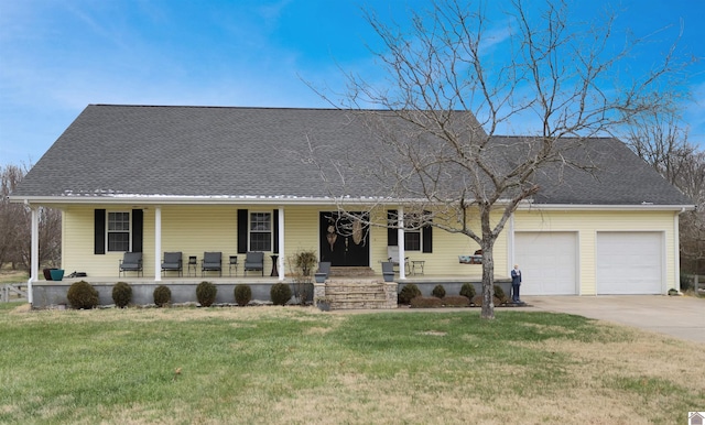 view of front of property with a front lawn, covered porch, and a garage