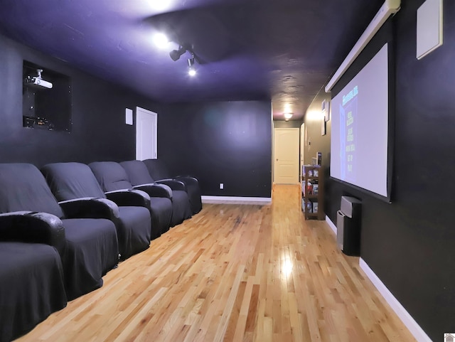 cinema with light hardwood / wood-style flooring