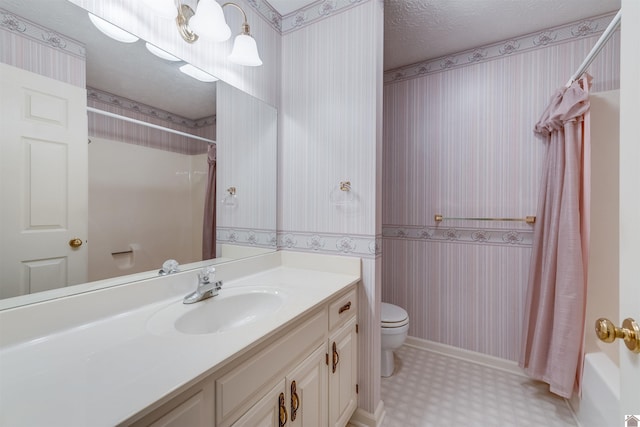 full bathroom with shower / tub combo with curtain, vanity, a textured ceiling, and toilet