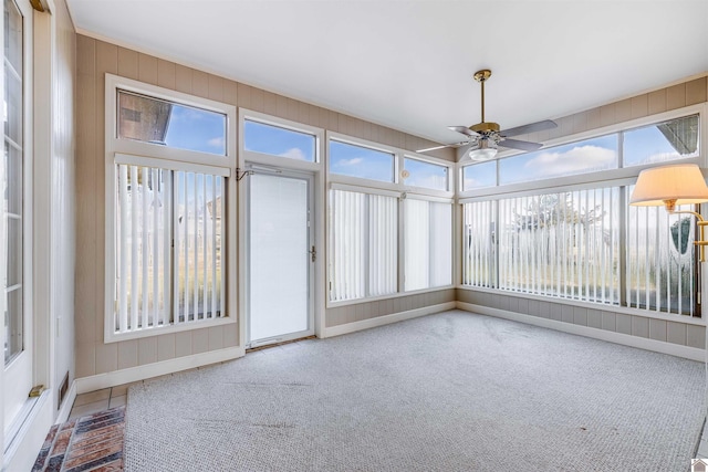 unfurnished sunroom with ceiling fan and a healthy amount of sunlight