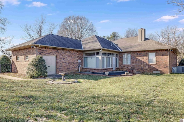 back of house with a sunroom and a yard