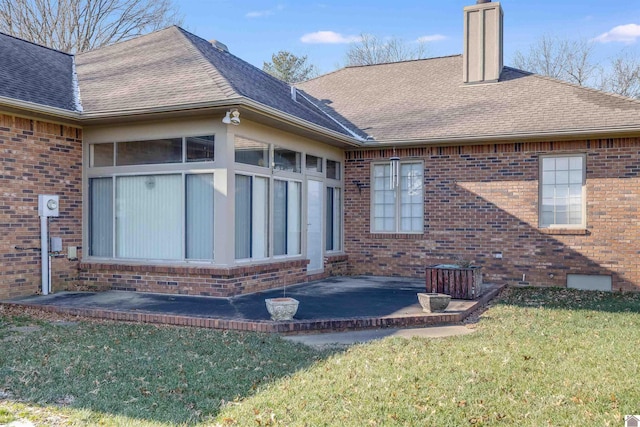 back of house with a yard and a patio