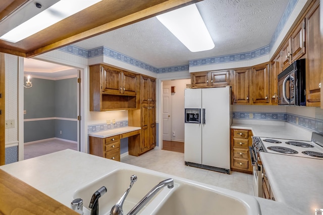 kitchen with white appliances and a textured ceiling