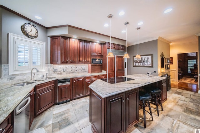 kitchen with sink, a kitchen breakfast bar, decorative light fixtures, a kitchen island, and black appliances