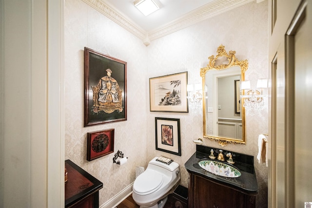 bathroom with hardwood / wood-style floors, vanity, toilet, and ornamental molding