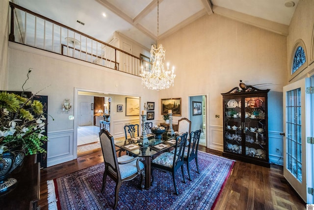 dining space with beamed ceiling, a high ceiling, a chandelier, and dark wood-type flooring