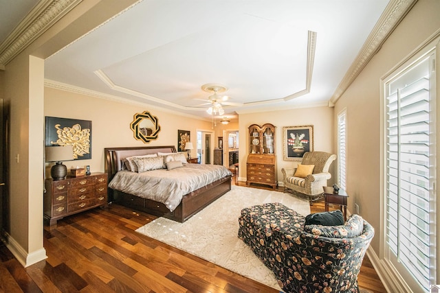 bedroom with a raised ceiling, ceiling fan, dark hardwood / wood-style flooring, and ornamental molding