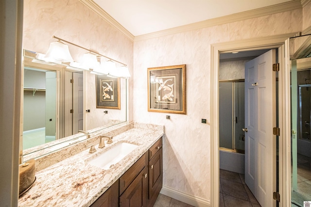 bathroom featuring tile patterned flooring, vanity, and crown molding