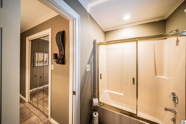 bathroom featuring tile patterned flooring, combined bath / shower with glass door, and ornamental molding