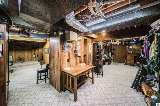 basement with carpet and wood walls