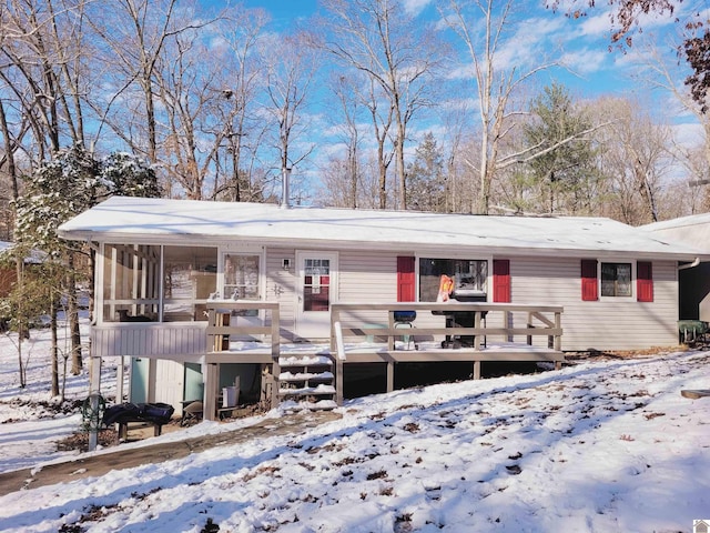 single story home with a deck and a sunroom