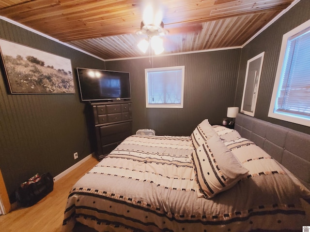 bedroom featuring wooden ceiling, light hardwood / wood-style flooring, ceiling fan, and ornamental molding