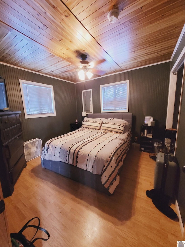 bedroom with multiple windows, light hardwood / wood-style floors, ceiling fan, and wooden ceiling