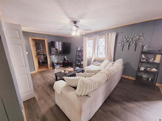 living room featuring a textured ceiling, ceiling fan, and dark hardwood / wood-style floors