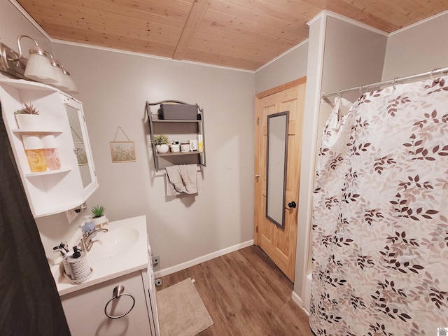 bathroom featuring walk in shower, wood-type flooring, vanity, wood ceiling, and ornamental molding