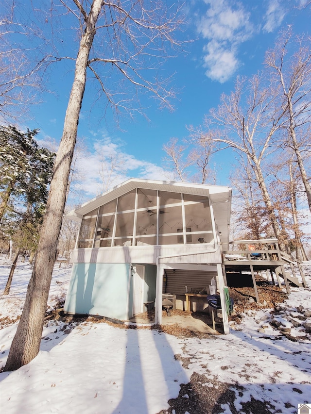 exterior space featuring a sunroom and ceiling fan