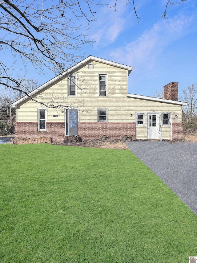 view of side of property with a lawn