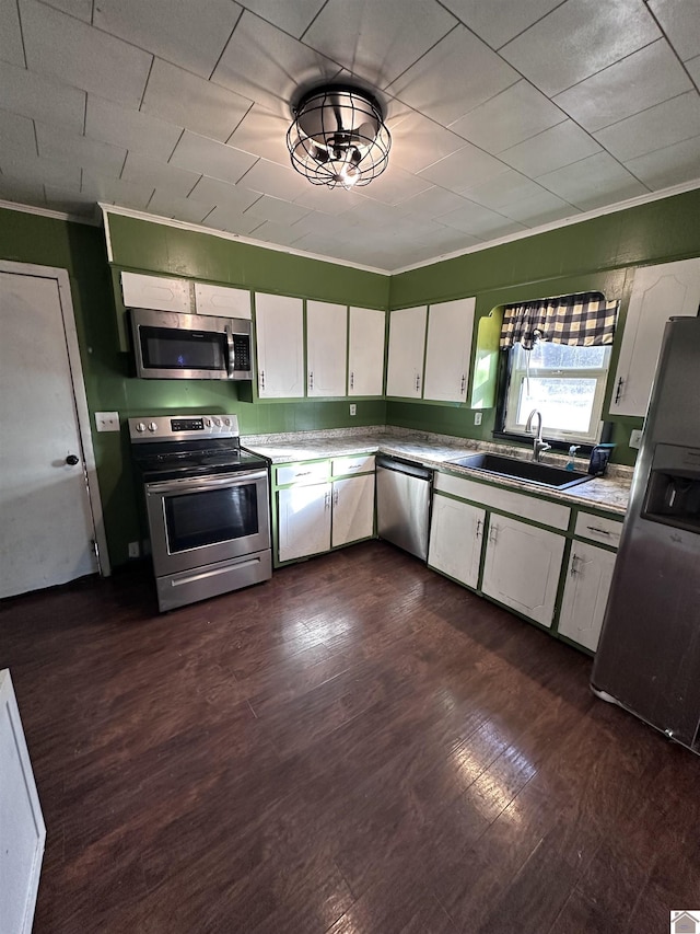 kitchen featuring dark hardwood / wood-style flooring, white cabinetry, sink, and appliances with stainless steel finishes