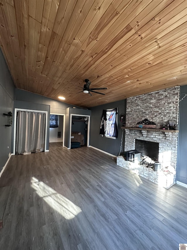 unfurnished living room featuring hardwood / wood-style flooring, ceiling fan, wood ceiling, and a brick fireplace