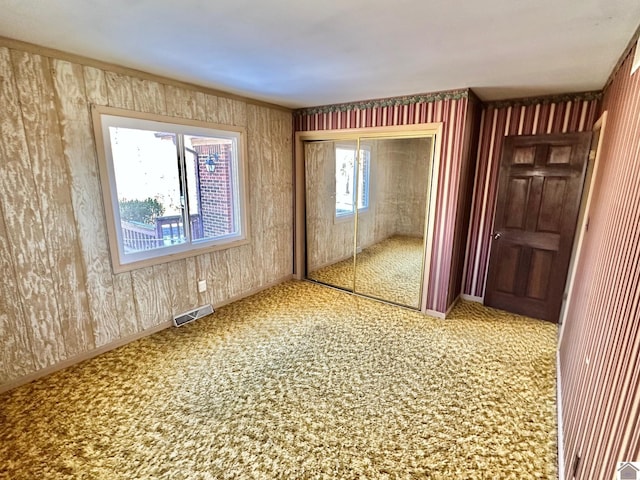 unfurnished bedroom featuring carpet floors and a closet