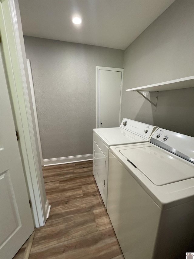 laundry room featuring independent washer and dryer and dark wood-type flooring