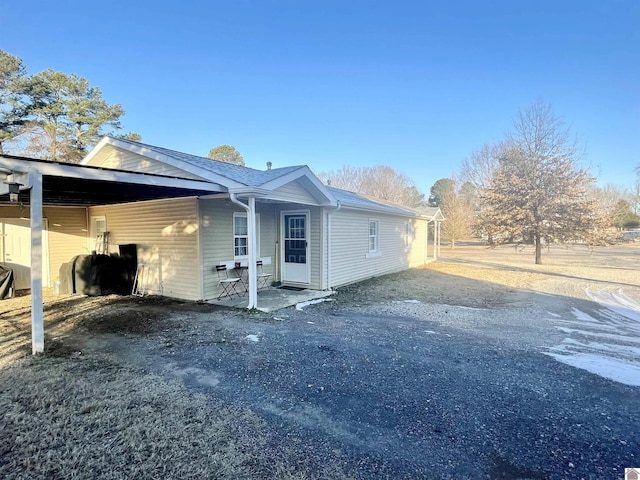 view of side of property with a carport