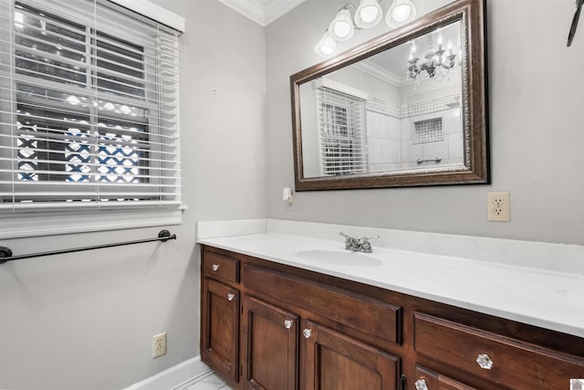 bathroom featuring vanity, a chandelier, and ornamental molding