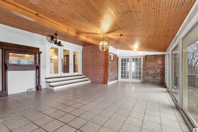 interior space featuring a notable chandelier, a healthy amount of sunlight, wooden ceiling, and french doors