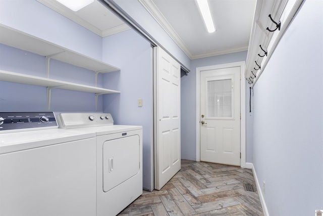 laundry room with washer and clothes dryer, light parquet flooring, and ornamental molding