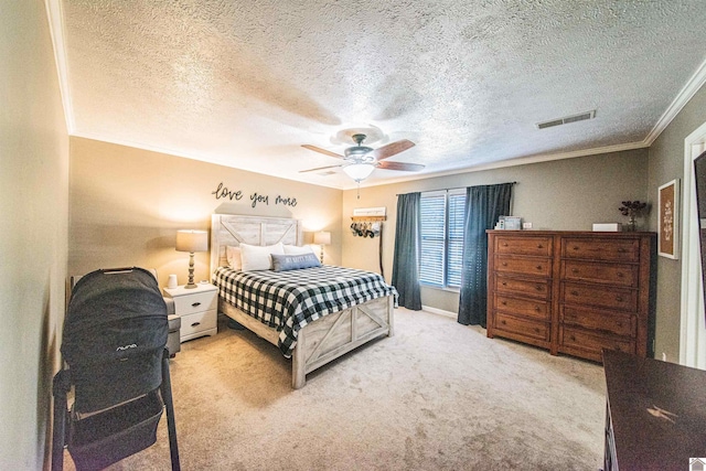 bedroom featuring ceiling fan, crown molding, light carpet, and a textured ceiling