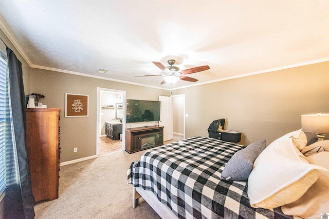 bedroom featuring ceiling fan, crown molding, light carpet, and ensuite bath