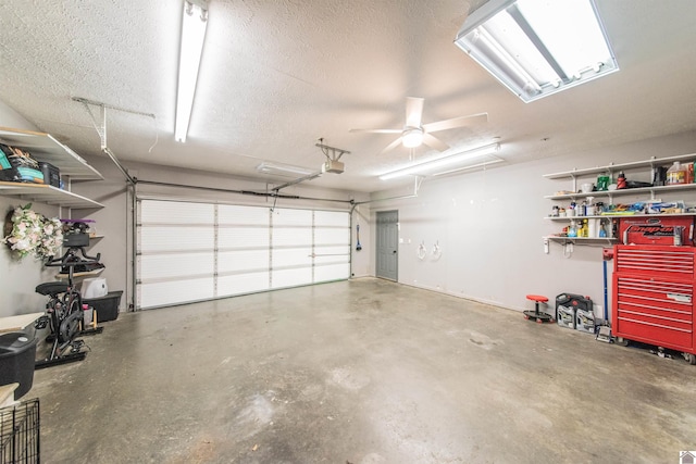 garage with a garage door opener and ceiling fan